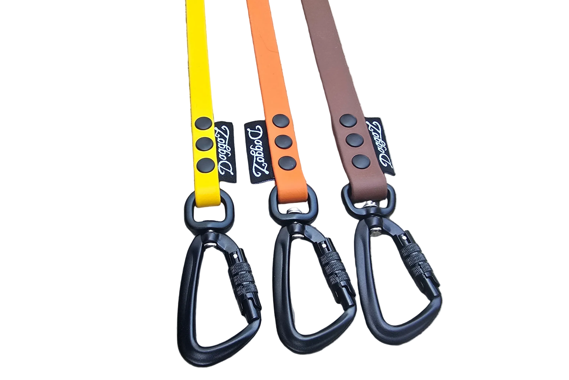 A selection of DoggoZ handleless BioThane drag lines in yellow, orange, and brown. The photo showcases the high-quality matte finish of the BioThane material, paired with heavy-duty black locking carabiners and durable rivets. These snag-resistant leashes are designed to give dogs freedom during hiking and off-leash training while ensuring safety.
