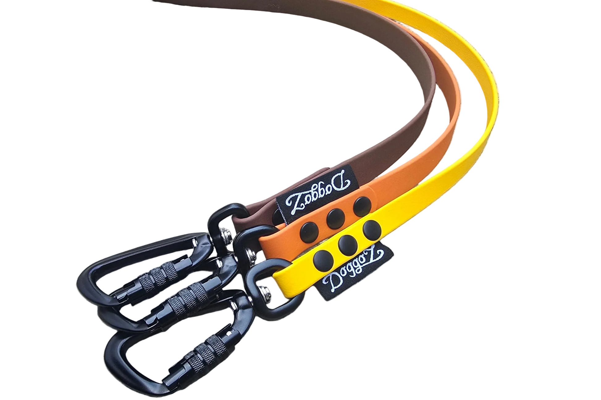 Three DoggoZ handleless BioThane drag lines in yellow, orange, and brown colors. The image shows the premium matte finish of the straps, heavy-duty black locking carabiners, and the DoggoZ brand label. These leashes are specifically designed for snag-resistant hiking and training adventures.