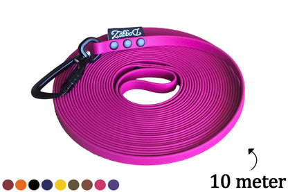 A neatly rolled up 10 meter DoggoZ BioThane long leash tracking leash in pink magenta, featuring a black auto-lock carabiner, the DoggoZ logo, and a color palette at the bottom.