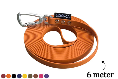 A neatly rolled up 6-meter DoggoZ BioThane long tracking leash in orange, featuring a silver auto-lock carabiner, the DoggoZ logo, and a color palette at the bottom.