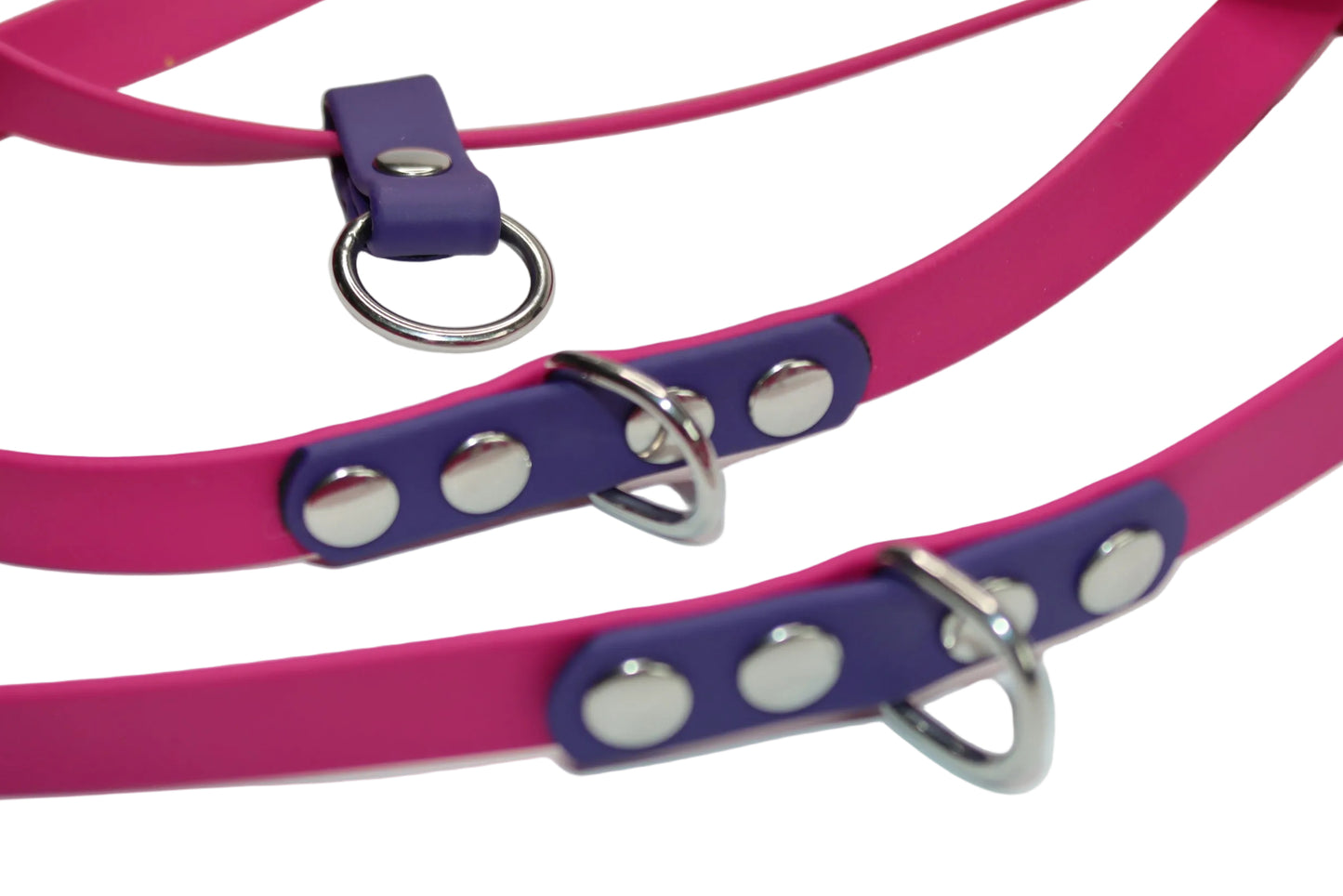Close-up detail of the DoggoZ Multi-Way Leash showing the premium pink BioThane material, purple accent tabs, and high-quality silver rivets and D-rings for maximum durability.