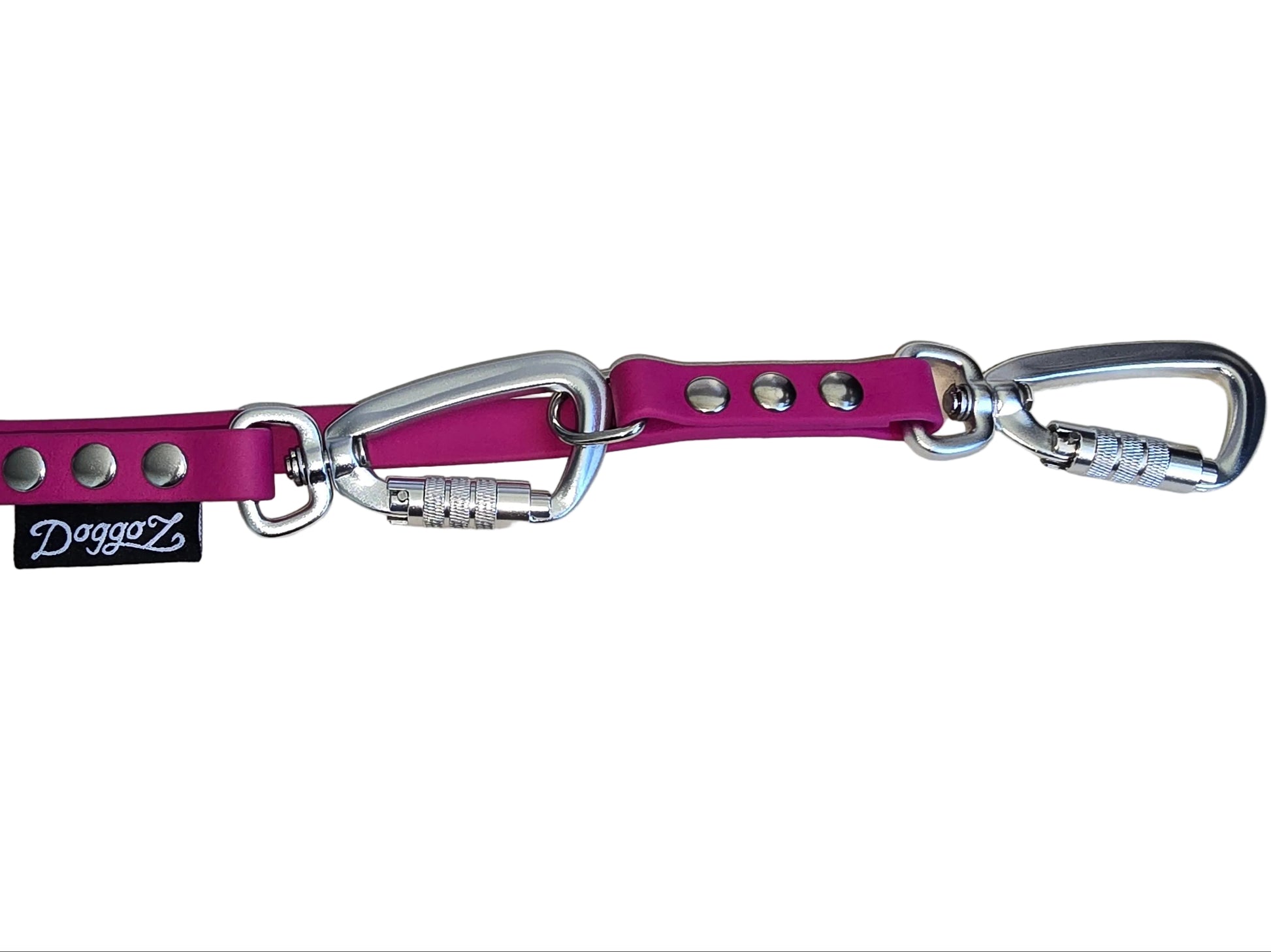 Detailed view of the DoggoZ Multi-Way Convertible Leash featuring two silver auto-locking carabiners clipped to pink BioThane. The shot highlights the industrial-strength silver rivets and the black DoggoZ brand logo tag.